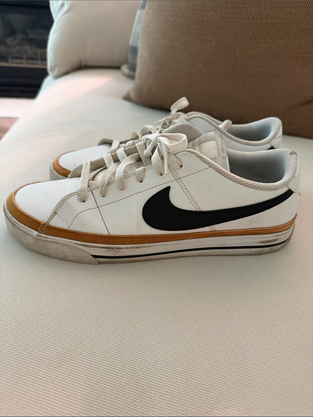 Nike White Low-Top Sneakers with Black Swoosh and Mustard Accent